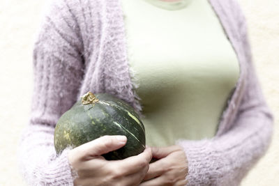 Midsection of woman holding apple