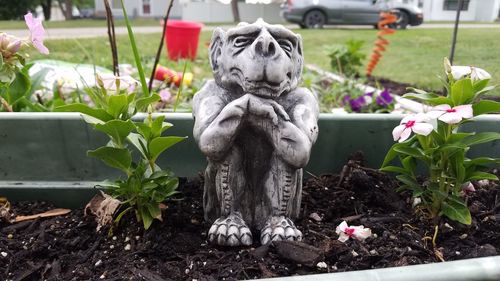 Statue of potted plants in yard