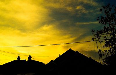 Low angle view of silhouette roof against sky