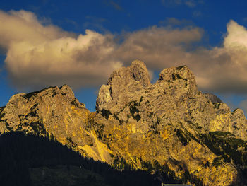 Low angle view of rock formation against sky