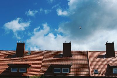 Low angle view of building against cloudy sky