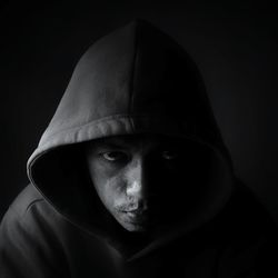 Close-up portrait of man wearing hood