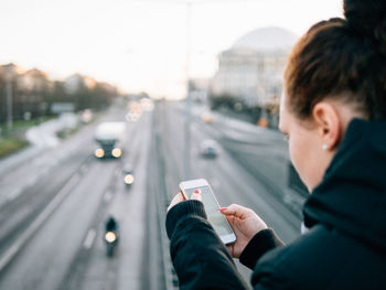 Woman standing on road in city