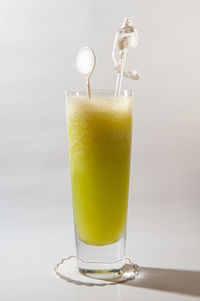 Close-up of drink in glass against white background