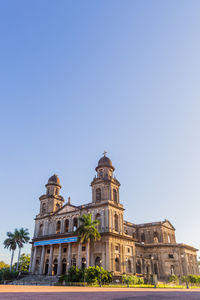 Low angle view of building against clear blue sky