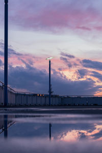 View of factory against sky during sunset