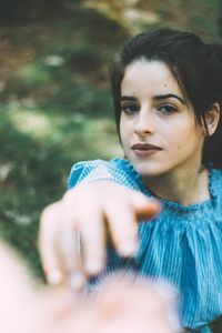 Portrait of beautiful woman holding camera