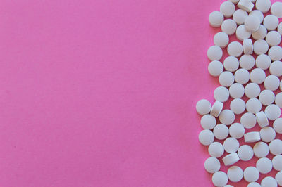 High angle view of multi colored pencils on pink background
