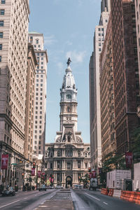 View of city street and buildings against sky