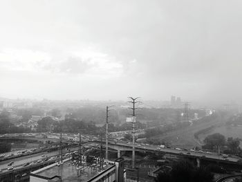 Aerial view of bridge in city against sky