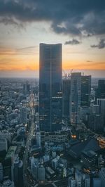 High angle view of illuminated cityscape against sky during sunset