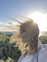 Portrait of beautiful woman against sky