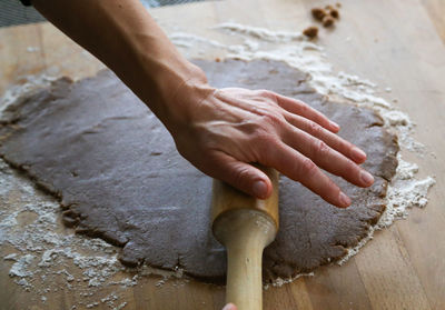 Midsection of person preparing food in kitchen