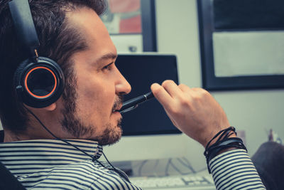 Businessman listening music while relaxing in office