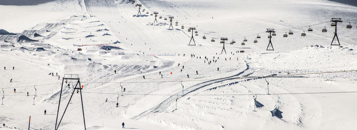 High angle view of ski lift over snow covered mountains