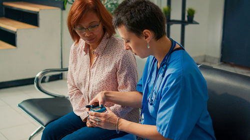 Side view of woman using mobile phone