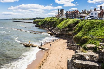 View of beach against cloudy sky