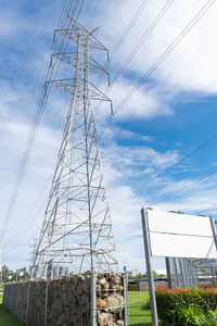Low angle view of electricity pylon against sky