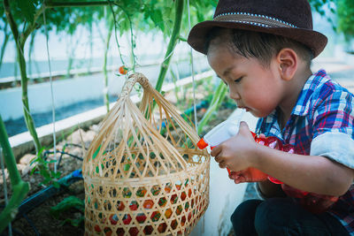 Full length of boy holding hat