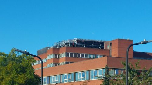 Low angle view of buildings against clear blue sky