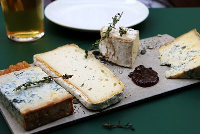 High angle view of cheese and food in plate on table