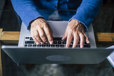 Midsection of man working on table