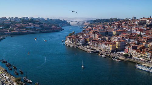 High angle view of town by sea against sky