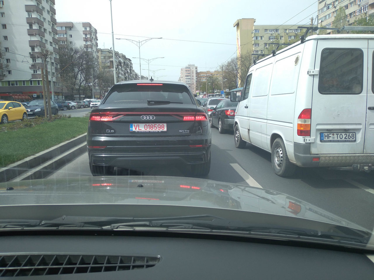 VEHICLES ON ROAD SEEN THROUGH WINDSHIELD