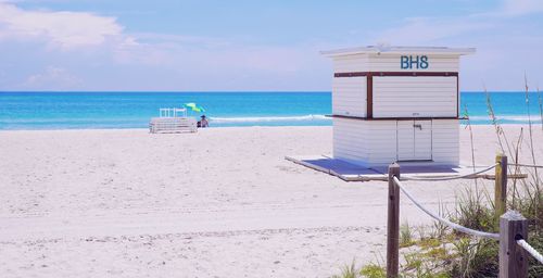 Lifeguard hut on beach against sky