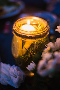 Close-up of illuminated tea light candles on flower