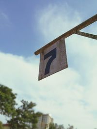 Low angle view of road sign against sky