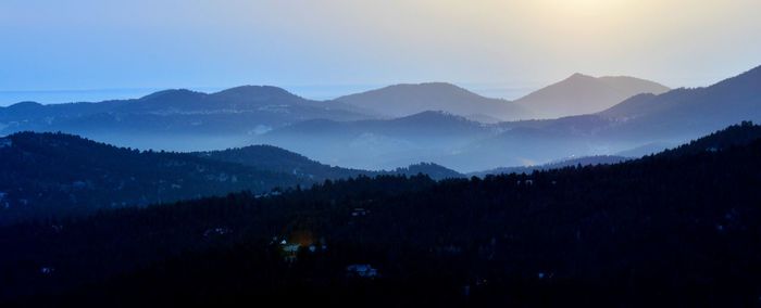 Scenic view of silhouette mountains against sky during sunset