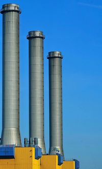 Low angle view of smoke stack against sky