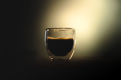 Close-up of drink on table against black background
