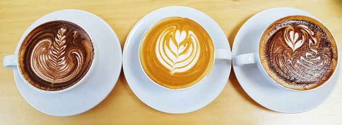 High angle view of coffee cups on table