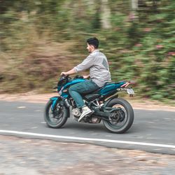 Man riding motorcycle on road