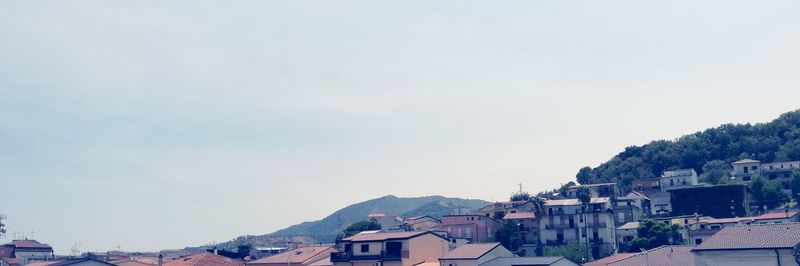 Houses in town against clear sky