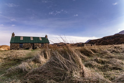 House on field against sky