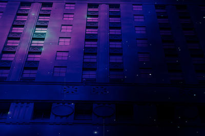 Low angle view of illuminated building at night