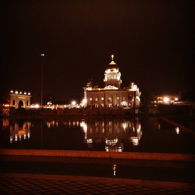 illuminated, night, building exterior, architecture, built structure, water, reflection, religion, place of worship, church, city, spirituality, sky, river, travel destinations, famous place, street light, waterfront, lighting equipment