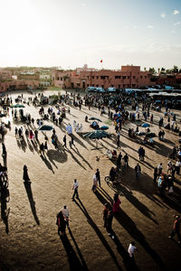 High angle view of people at town square during sunset