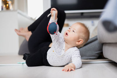 Portrait of cute baby boy sitting on floor