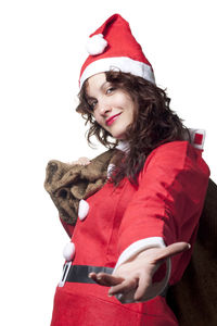Smiling young woman wearing hat against white background