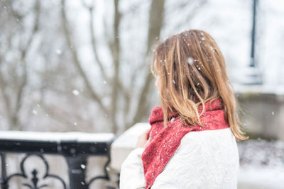 Close-up of girl with snow on tree