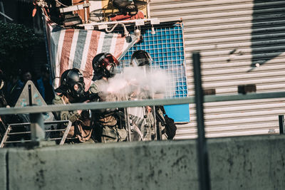 People on street against buildings in city