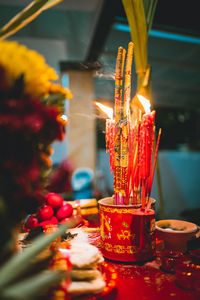 Close-up of illuminated candles in temple