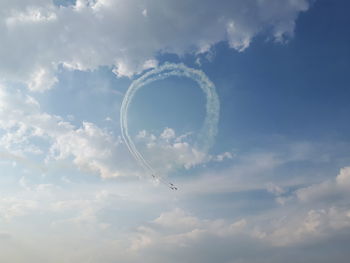 Low angle view of airplane flying against sky