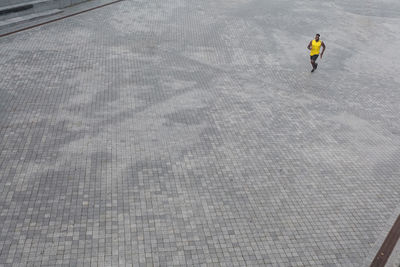 High angle view of man walking on snow