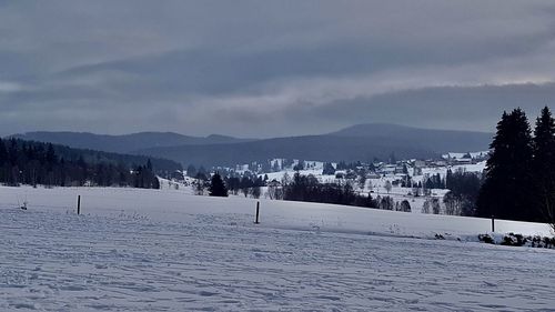 Scenic view of snow covered mountains against sky