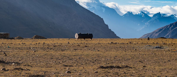 Construction machinery on field against mountain